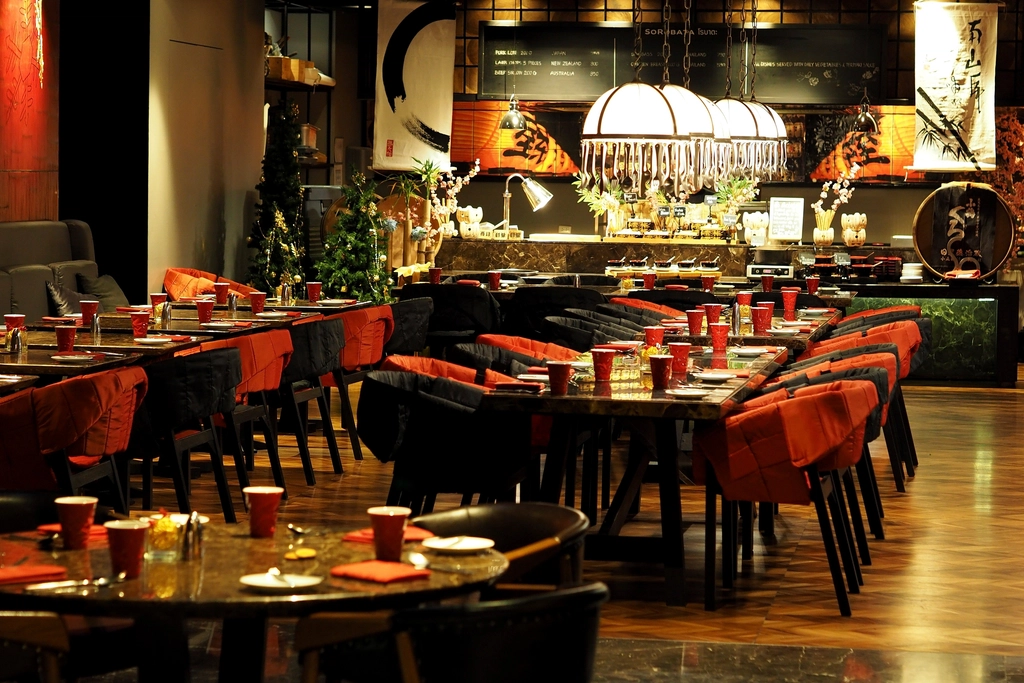Italian restaurant interior with warm lighting and wood decor.