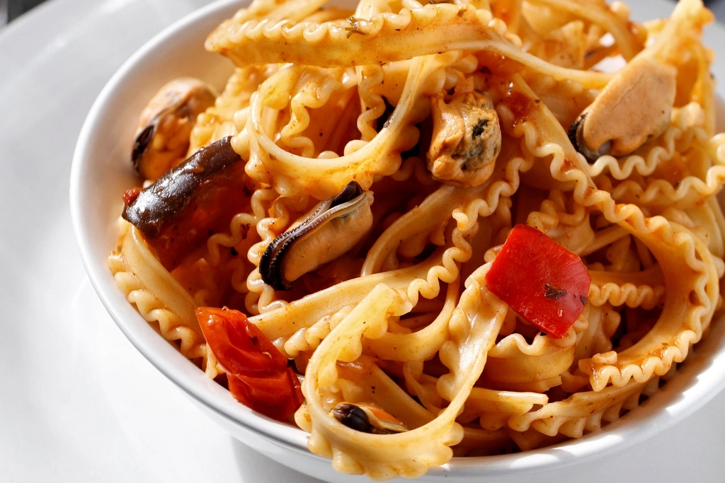 Close-up of fresh pasta served with rich sauce.